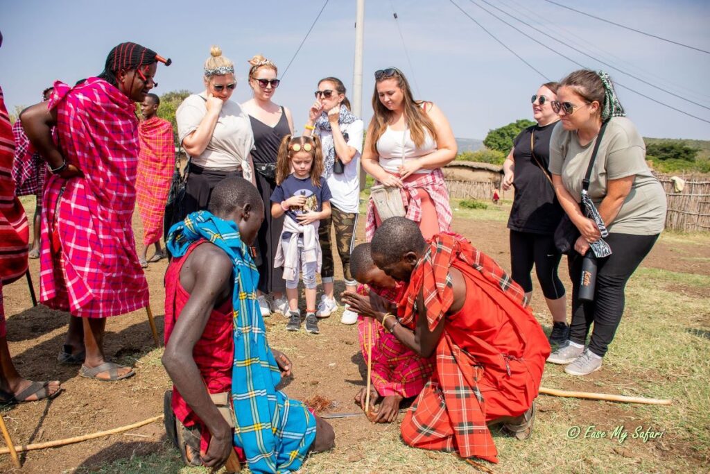 Guests Learn how to traditionally light a fire during a Maasai Mara Community Village Visit