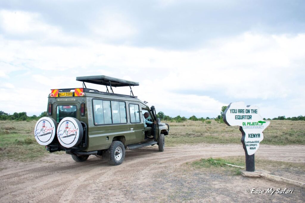 Crossing the line at Ol Pejeta: An Ease My Safari Landcruiser Jeep pauses for a photo-op at the Equator during a thrilling wildlife adventure in Ol Pejeta Conservancy
